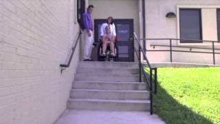 Descending steps with a wheelchair with assistance