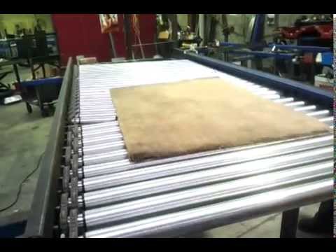 Test aligning carpets on driven roller conveyor 