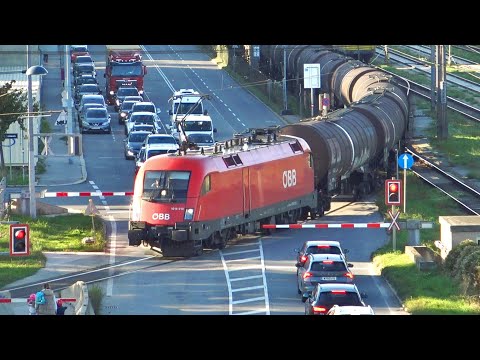 Trains in Wien Praterkai. Railway crossing next to the Danube river. ÖBB, CD, GySev, Railjet, BoxxP