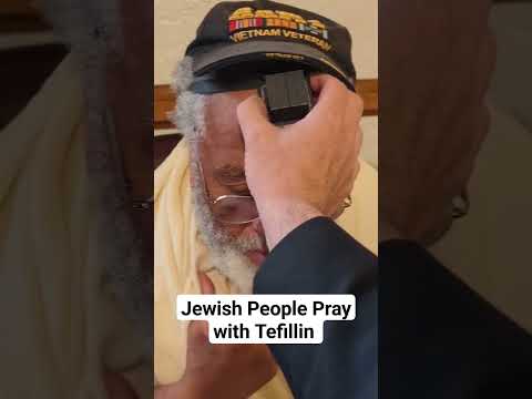 Jewish people pray wearing prayer boxes, tefillin, which are filled with handwritten scrolls