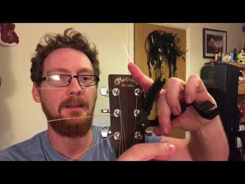 Part of a video titled How to Coil or Curl Guitar Strings - YouTube