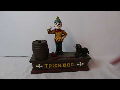 Lot 561 - Trick dog metal coin bank