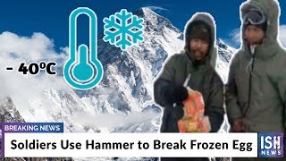 Soldiers Use Hammer to Break Frozen Egg