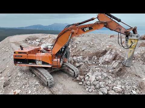 CAT 385C Excavator with Epiroc HB 1000 Breaker Prepares Wind Turbine Base at 1,000m Altitude
