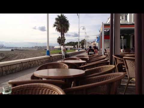 Malaga, Spain - Relaxing in a seaside cafe outside with Street buskers