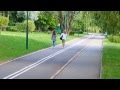 Two Girls In Jeans Shorts Walking With A Camera On The Road