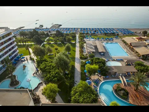 Oberflächenansicht des Esperides Beach Resorts mit Swimmingpools, Liegestühlen und Palmen.