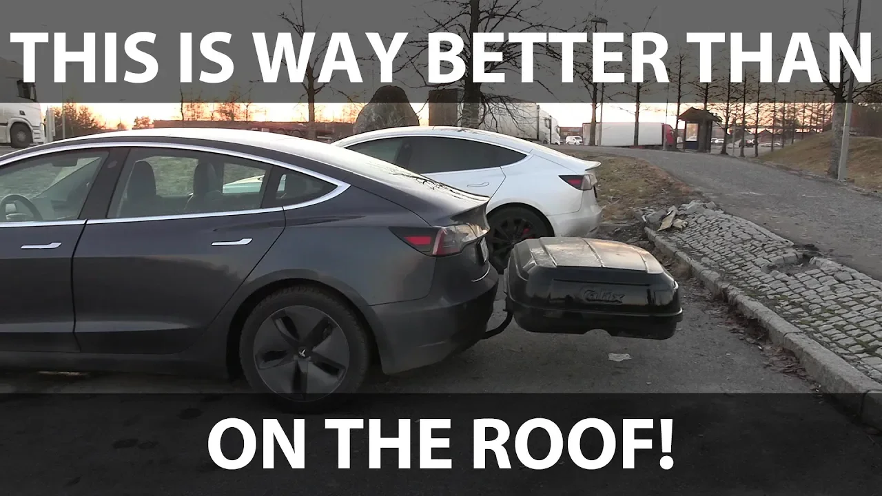 Tesla Model 3 with roof box on tow hitch