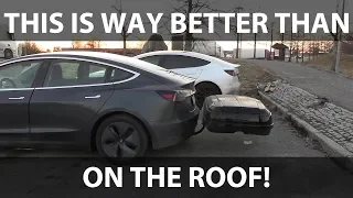 Tesla Model 3 with roof box on tow hitch