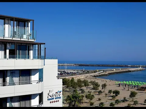 Außenansicht des Kriti Beach Hotels mit mehreren Stockwerken, Terrassen, Swimmingpool und Meer im Hintergrund.