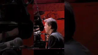 Eric and Paul McCartney performing “While My Guitar Gently Weeps” at a concert for George Harrison.